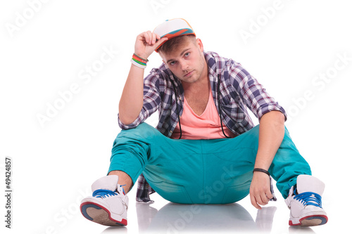 Photo: dancer on the floor holding his hat dancer on the floor holding his hat