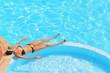 A slender young woman in a bikini