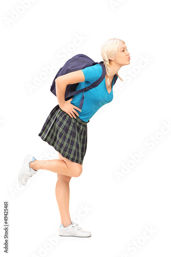 Photo: Full length portrait of a female student with school bag giving Full length portrait of a female student with school bag giving