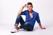 man with legs crossed holding forehead
