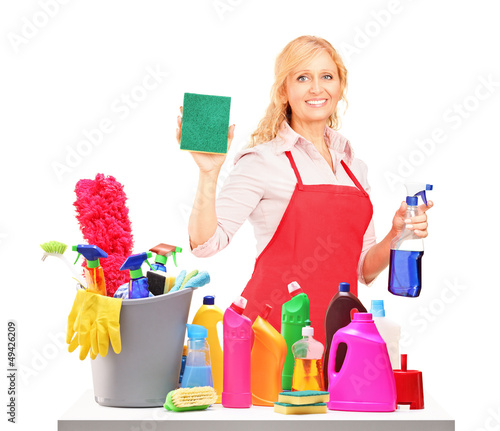 Photo: Mature female cleaner posing with cleaning equipment Mature female cleaner posing with cleaning equipment