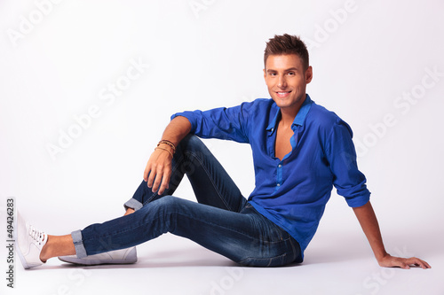 Photo: sitting relaxed on floor & smiling sitting relaxed on floor & smiling