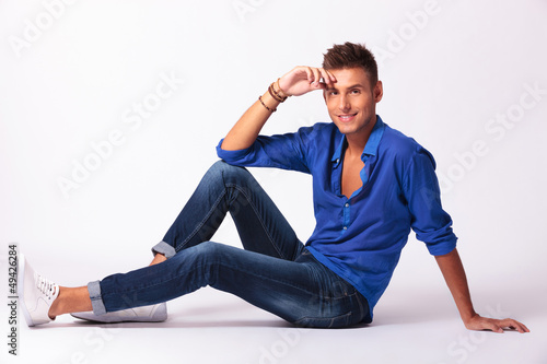 Photo: seated man smiles at you seated man smiles at you