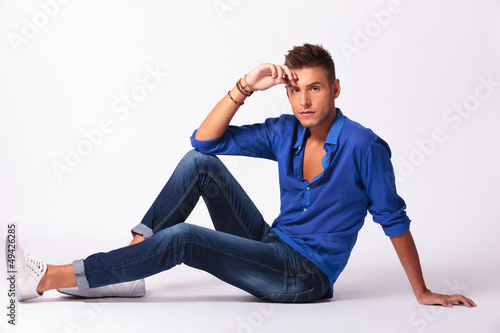 Photo: man sitting on floor looking at you man sitting on floor looking at you