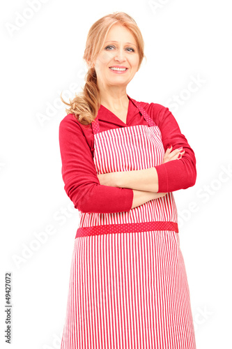 Photo: Smiling female worker wearing an apron and posing Smiling female worker wearing an apron and posing