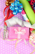 Rolls of Christmas wrapping paper with ribbons, bows