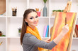 beautiful young woman painter at work,
