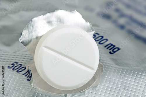 Photo: White pill in a pack very close up White pill in a pack very close up