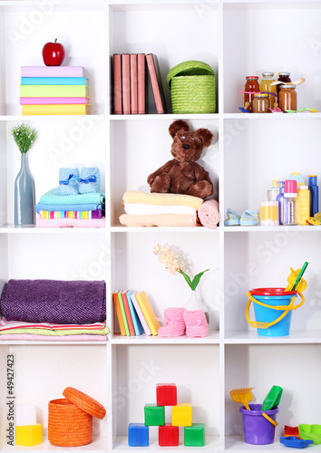 Photo: Beautiful white shelves with different baby related objects Beautiful white shelves with different baby related objects