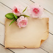 wooden background with paper frame and flowers