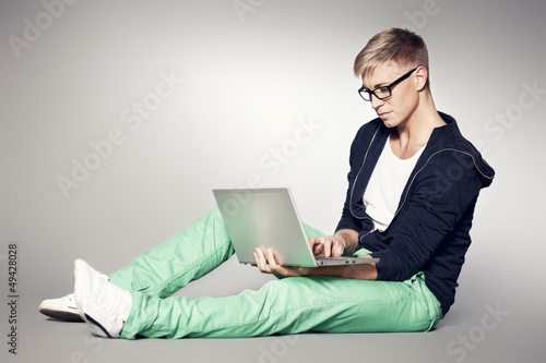 Photo: Focused student working on laptop. Focused student working on laptop.