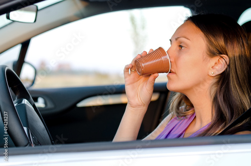 Photo: Woman driver stopping for a drink Woman driver stopping for a drink