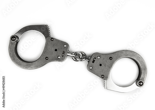 Photo: police handcuffs on white police handcuffs on white