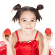 Little girl with strawberry on white background