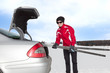 Foto: Woman with car during unloading of cross-country skis Woman with car during unloading of cross-country skis