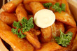 Appetizing village potatoes in bowl on wooden table close-up