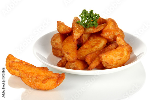 Photo: Appetizing village potatoes on plate isolated on white Appetizing village potatoes on plate isolated on white