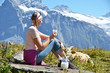 Girl with a jug of milk and a cow. Jungfrau region, Switzerland