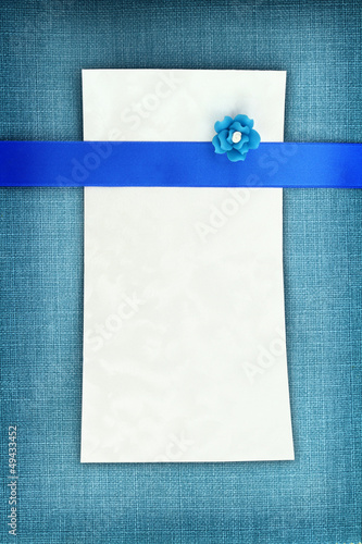 Photo: Empty card on blue fabric texture Empty card on blue fabric texture