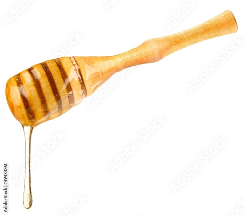 Photo: drop honey on wooden dipper drop honey on wooden dipper