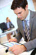 Businessman using digital tablet in office