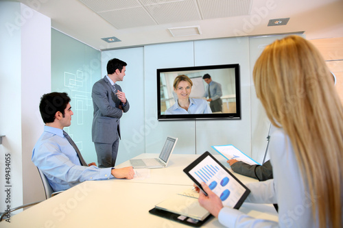 Photo: Business people attending videoconference meeting Business people attending videoconference meeting