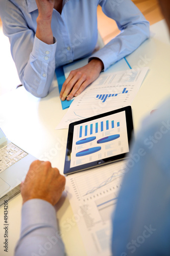 Photo: Closeup of tablet screen presenting charts Closeup of tablet screen presenting charts