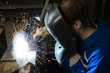 Man welding steel creating many sparks