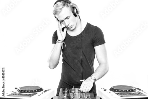Photo: DJ at work in front of white background DJ at work in front of white background