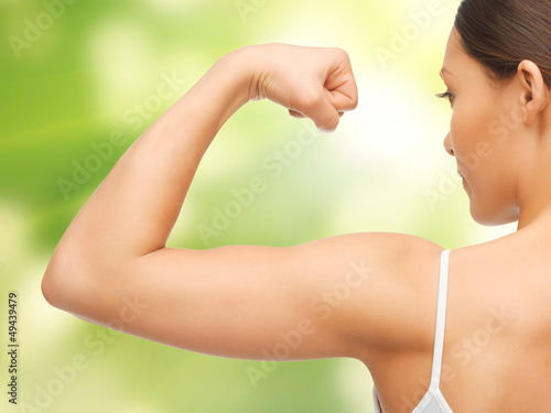 Photo: sporty woman flexing her biceps sporty woman flexing her biceps