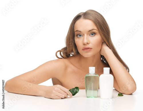 Photo: woman with cosmetic bottles woman with cosmetic bottles