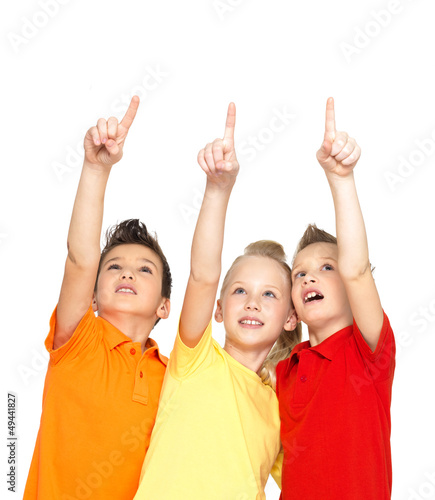 Photo: Portrait of the happy children point up by finger - isolated on Portrait of the happy children point up by finger - isolated on