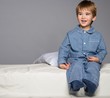Little boy wearing blue pyjamas in bed