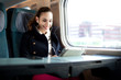 Young woman traveling on the train in business class
