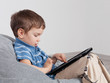 Boy playing on tablet