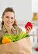 Happy young housewife examines purchases after shopping