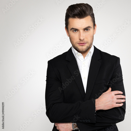 Photo: Fashion young businessman in black suit Fashion young businessman in black suit
