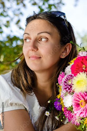 Photo: Thoughtful woman with beautiful flowers Thoughtful woman with beautiful flowers