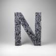 Letter N made out of scrambled small letters in studio setting
