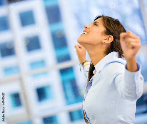 Photo: Successful business woman with arms up Successful business woman with arms up