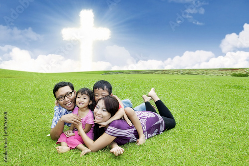 Photo: Happy Christian family on the grass Happy Christian family on the grass