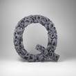 Letter Q made out of scrambled small letters in studio setting