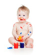 Funny dirty baby boy with paints. Isolated on white background