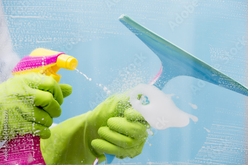 Photo: Cleaning - cleaning window pane with spray detergent Cleaning - cleaning window pane with spray detergent