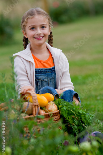 Photo: Vegetable garden - lovely girl with basket of vegetables Vegetable garden - lovely girl with basket of vegetables
