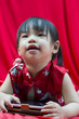 Photo: China girl in traditional Chinese red Tang suit greeting China girl in traditional Chinese red Tang suit greeting
