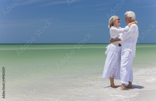 Photo: Happy Senior Couple Embracing on Tropical Beach Happy Senior Couple Embracing on Tropical Beach