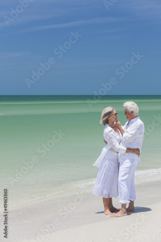 Photo: Happy Senior Couple Embracing on Tropical Beach Happy Senior Couple Embracing on Tropical Beach