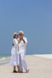 Happy Senior Couple Dancing on Tropical Beach