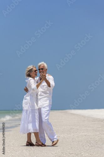 Photo: Happy Senior Couple Dancing on Tropical Beach Happy Senior Couple Dancing on Tropical Beach